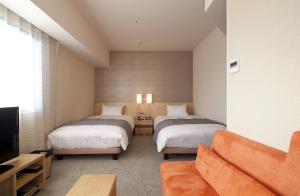 Cocochee Hotel Numazu tesisinde bir odada yatak veya yataklar
