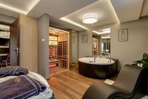 a large bathroom with a tub and a bed at Love and Dream Élményvilla in Zalakaros