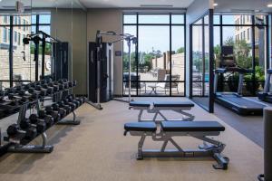 a gym with rows of treadmills and machines at Courtyard by Marriott Thomasville Downtown in Thomasville