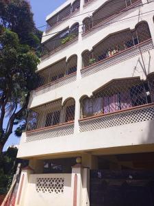 een wit gebouw met balkons en planten erop bij Nimo - One Bedroom Beachroad Deluxe Apartment, Mtwapa in Mombasa