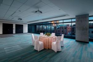 a conference room with a table and white chairs at Residence Inn by Marriott Calgary Downtown/Beltline District in Calgary