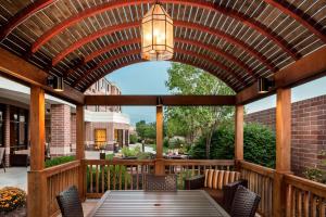 a wooden pergola with a table and chairs on a patio at Courtyard by Marriott Columbia in Columbia