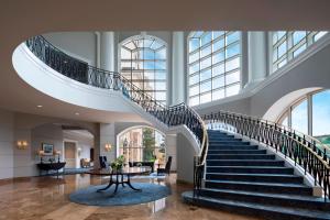 a spiral staircase in a building with a lobby at The Ballantyne, a Luxury Collection Hotel, Charlotte in Charlotte