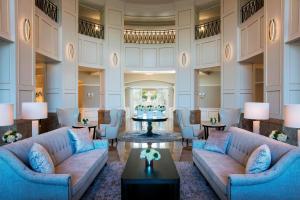 a lobby with couches and a table with a cake at The Ballantyne, a Luxury Collection Hotel, Charlotte in Charlotte