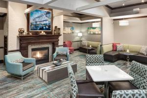 a hotel lobby with a fireplace and furniture at Residence Inn Kansas City Country Club Plaza in Kansas City