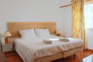 ein Schlafzimmer mit einem Bett mit zwei Handtüchern darauf in der Unterkunft Ericeira - S.ta Marta in Ericeira