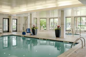 a swimming pool in a building with glass windows at Courtyard by Marriott Springfield in Springfield