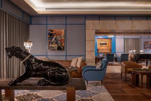 a lobby with a statue of a horse on a table at The St. Regis Doha in Doha