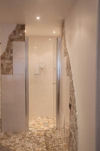 a shower with a glass door in a bathroom at Hotel Stadtkrug in Weiden