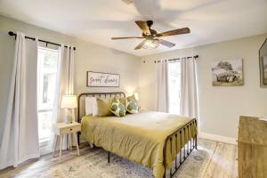 a bedroom with a bed and a ceiling fan at Quiet Conroe Getaway with Patio, Golf Views! in Conroe