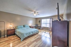 a bedroom with a bed and a ceiling fan at Family Home with Yard about 15 Mi to Downtown! in Mooresville