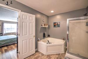 a bathroom with a tub and a shower and a bed at Family Home with Yard about 15 Mi to Downtown! in Mooresville +23 photos