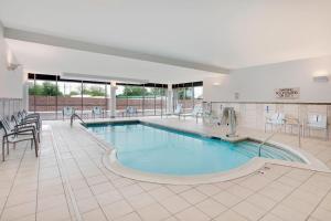 una gran piscina con sillas y una mesa en un hotel en SpringHill Suites by Marriott Murray, en Murray