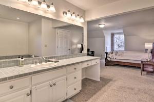 a bathroom with a sink and a bed in a room at Portland Area Home, 32 Mi to Mt Hood! in Damascus