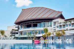 a large building with a swimming pool in front of it at Renaissance Bali Uluwatu Resort & Spa in Uluwatu