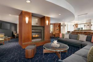 a living room with a couch and a fireplace at Courtyard Lancaster in Lancaster