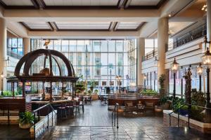 a restaurant with tables and chairs and a large window at Sheraton New Orleans Hotel in New Orleans