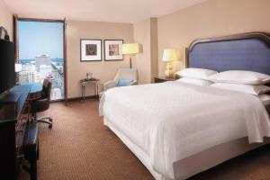a hotel room with a large white bed and a window at Sheraton New Orleans Hotel in New Orleans