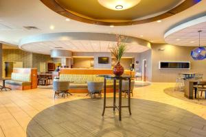 a lobby with a table with a vase on it at SpringHill Suites by Marriott Lawrence Downtown in Lawrence