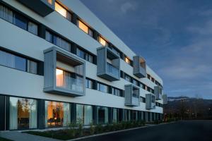 una rappresentazione di un edificio con ampie finestre di AC Hotel by Marriott Saint-Julien-en-Genevois a Saint-Julien-en-Genevois