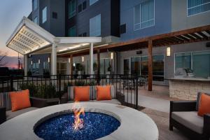 a fire pit in a patio in front of a building at TownePlace Suites Fort Worth Northwest Lake Worth in Fort Worth