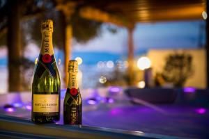 two bottles of wine sitting on a table at Myronis Villa Corfu Town in Corfu Town