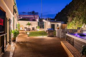 a patio with a grill in a backyard at night at Myronis Villa Corfu Town in Corfu Town
