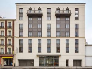 a large white building with balconies on it at Tribe Paris Saint Ouen in Saint-Ouen