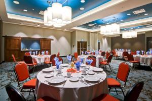 a banquet room with tables and chairs and a projection screen at TownePlace Suites by Marriott Kincardine in Kincardine