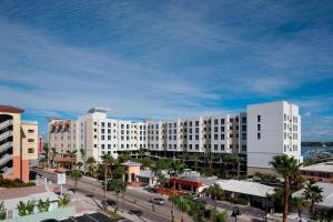 a large white building with palm trees and a street at Residence Inn by Marriott Clearwater Beach in Clearwater Beach
