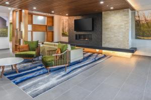 a lobby with a couch and chairs and a fireplace at Fairfield Inn & Suites Ontario Rancho Cucamonga in Rancho Cucamonga