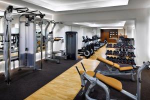 a gym with a lot of treadmills and machines at Amman Marriott Hotel in Amman