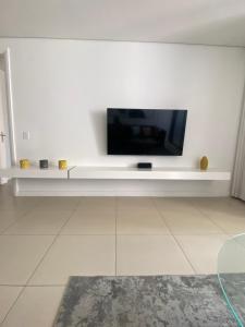 a living room with a flat screen tv on a white wall at 608 Beacon Rock in Durban