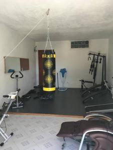 a gym with a punching bag hanging from the ceiling at Villa Berio Tre - Kelan in Villa Viani