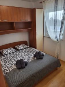 a bedroom with a bed with two towels on it at Apartma DOLORES in Vodnjan