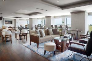 a lobby with couches and tables and chairs at Atlanta Airport Marriott Gateway in Atlanta