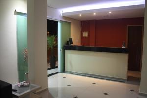 a lobby with a reception desk in a building at Hotel Portobello in Aparecida