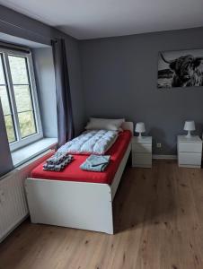 a bedroom with a bed with a red blanket at Flensburg Zentrum 69 01 in Flensburg