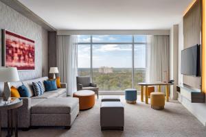 a living room with a couch and a tv at JW Marriott Orlando Bonnet Creek Resort & Spa in Orlando