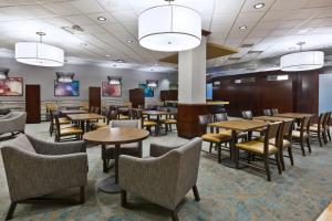 a dining room with tables and chairs and lights at Courtyard Omaha La Vista in La Vista