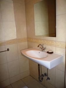 a bathroom with a sink and a mirror at Home Sweet Home in Rīga