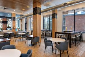 a restaurant with tables and chairs and windows at Residence Inn By Marriott Philadelphia Bala Cynwyd in Bala-Cynwyd