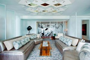 a living room with two couches and a chandelier at W New York - Times Square in New York