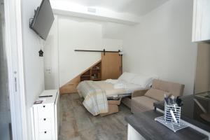 a living room with a bed and a couch at B&B Nonna Maria in Termoli