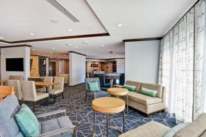 a waiting room with couches and tables at TownePlace Suites by Marriott Bridgewater Branchburg in Branchburg Park