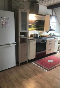 a kitchen with a white refrigerator and a stove at Monteurzimmer Ostalb in Lauchheim