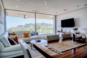 a living room with a couch and a table at Altos de Montserrat 2 1 in Herradura