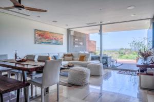 a living room with a couch and a table at Altos de Montserrat 2 1 in Herradura