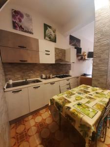 a small kitchen with a table and a sink at Tourist Rental Home ROMA in Rome