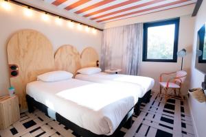 Ένα ή περισσότερα κρεβάτια σε δωμάτιο στο ibis Styles Montauban